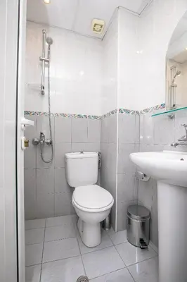 a bathroom with a toilet and a sink at Hotel Astra in Sandanski