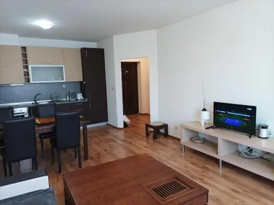 a living room with a kitchen and a dining room at Apartment Detelina Residence in Bansko