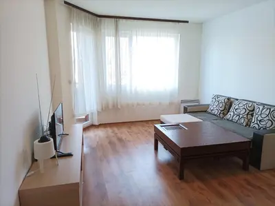 a living room with a couch and a coffee table at Apartment Detelina Residence in Bansko