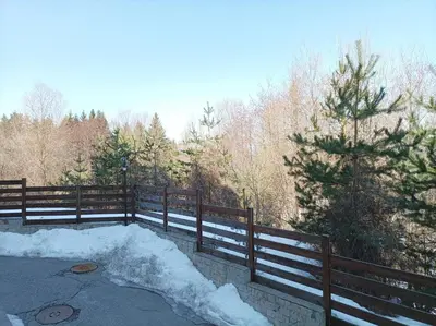 a pile of snow next to a fence at Apartment Detelina Residence in Bansko