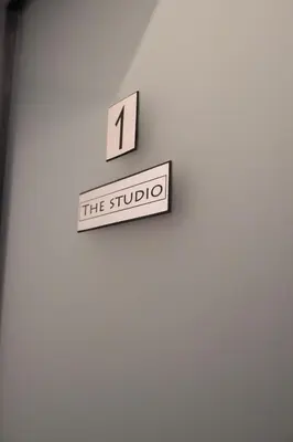 a sign that reads the studio on a wall at FELIX KANITZ Apartments - in the heart of Kapana district in Plovdiv