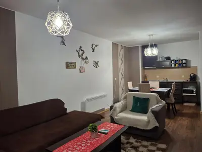 a living room with a couch and a table at Илен 433 Bansko Royal Towers in Bansko