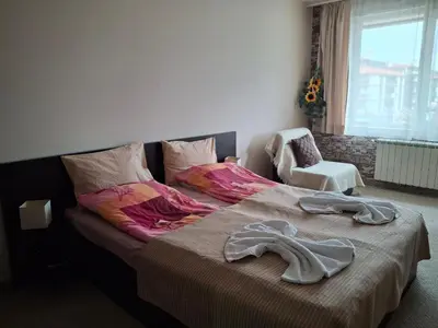 a bedroom with a large bed with clothes on it at Илен 433 Bansko Royal Towers in Bansko