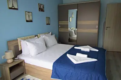 a bedroom with a large bed with blue walls at New & Comfortable home in Blagoevgrad center in Blagoevgrad