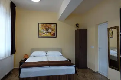 a bedroom with a bed and a picture on the wall at Борник Хил / Bornik Hill in Devin