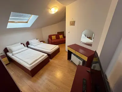 a small room with two beds and a mirror at Todorini Kuli Apartments in Bansko