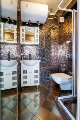 a bathroom with two sinks and a toilet at Funky apartment in Studentski Grad in Sofia