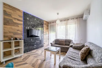 a living room with a couch and a table at Sunny Apartment in Studentski grad, behind UNSS in Sofia