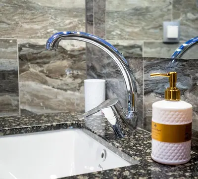 a bathroom counter with a sink and a faucet at Sunny Apartment in Studentski grad, behind UNSS in Sofia