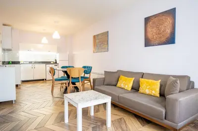 a living room with a couch and a table at Sunny Apartment in Studentski grad, behind UNSS in Sofia