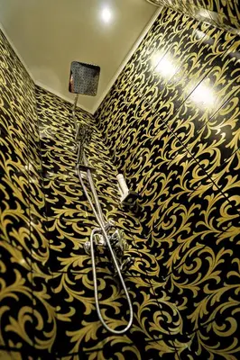 a bathroom with a black and gold patterned wall at Hotel CITY Petrich in Petrich