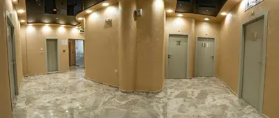 a hallway with a row of doors in a building at Hotel CITY Petrich in Petrich