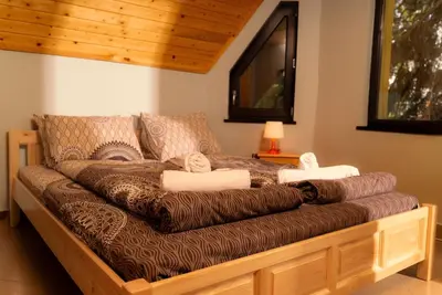 a brown couch with towels on it in a room at Почивна станция Сомат in Dospat