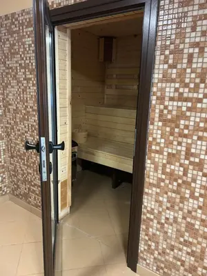 an open door to a sauna in a building at Почивна станция Сомат in Dospat