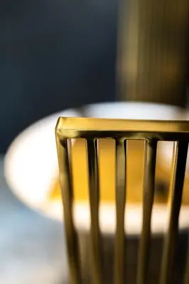 a wooden chair in front of a plate of food at THE HIDDEN BANK: Silver Bullet in Plovdiv