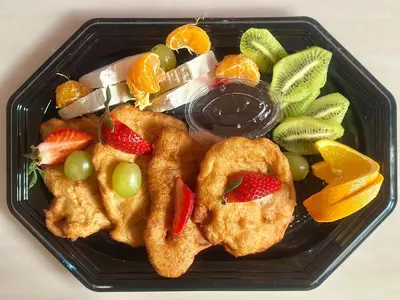 a black plate of food with fruit on it at THE HIDDEN BANK: Silver Bullet in Plovdiv