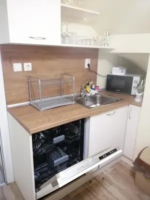a small kitchen with a sink and a microwave at дом Тодор и Тота Мутевски in Troyan