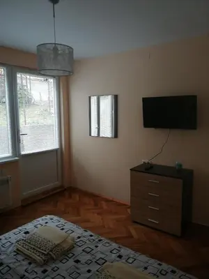 a bedroom with a bed and a flat screen tv at дом Тодор и Тота Мутевски in Troyan