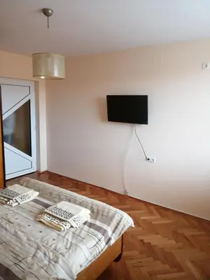 a room with a bed and a flat screen tv at дом Тодор и Тота Мутевски in Troyan