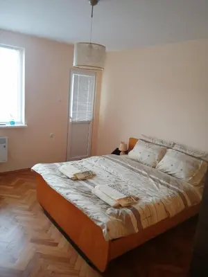 a bedroom with a large bed with towels on it at дом Тодор и Тота Мутевски in Troyan