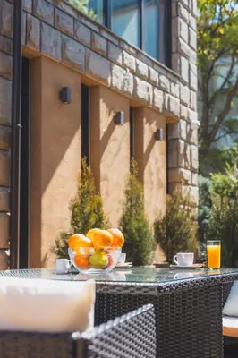 a bowl of oranges on a table on a patio at HIDDEN BANK: Golden in Plovdiv