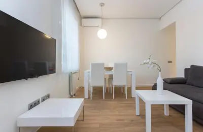 a living room with a couch and a table at Modern Apartment in the City Center in Sofia