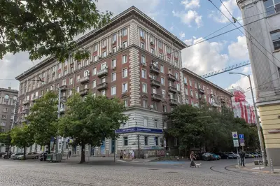 a large brick building on a city street at Modern Apartment in the City Center in Sofia