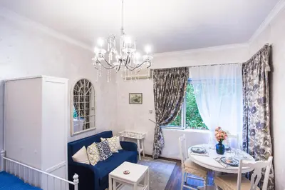 a living room with a blue couch and a table at TOP CENTER Designer studio 1 minute to NDK&Vitosha by Flat Mаnager in Sofia