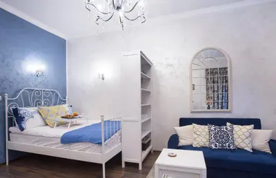 a small room with a bed and a chandelier at TOP CENTER Designer studio 1 minute to NDK&Vitosha by Flat Mаnager in Sofia
