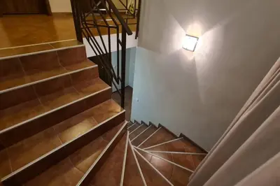 an overhead view of a staircase with a light on the wall at Двете къщи в планината in Beli Osŭm