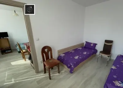 a bedroom with a purple bed and a chair at Al Colosseo in Zvŭnichevo