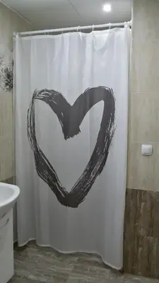 a black heart drawn on a shower curtain in a bathroom at Парк Апартаменти Юлия in Sandanski