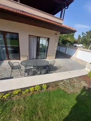 a patio with a table and chairs in front of a house at Stella Guesthouse in Sapareva Banya