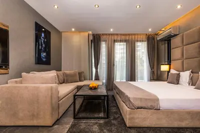a hotel room with a bed and a couch at SOHO Apart House in Plovdiv