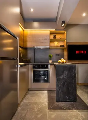 a kitchen with stainless steel appliances and a refrigerator at SOHO Apart House in Plovdiv