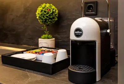 a coffee machine sitting on a counter with a tray of food at SOHO Apart House in Plovdiv