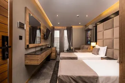 a hotel room with two beds and a mirror at SOHO Apart House in Plovdiv