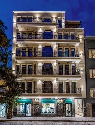 a tall white building with balconies at night at SOHO Apart House in Plovdiv