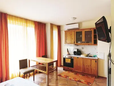 a kitchen with a table and a kitchen with a stove at Studio in Murphys Lodge in Bansko