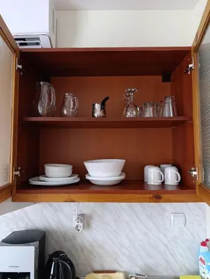 a wooden shelf with dishes and utensils on it at Studio in Murphys Lodge in Bansko