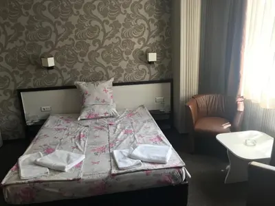 a bedroom with a bed with towels on it at Casa Blanca in Sofia