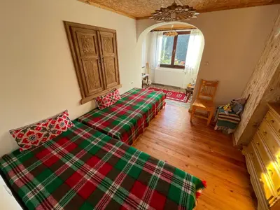 a bedroom with two beds in a room at Музикалната къща in Breze