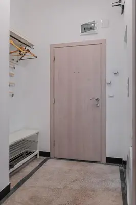 a door in a room with a white wall at Bright Apartment in the Heart of the City by Flat Mаnager in Sofia