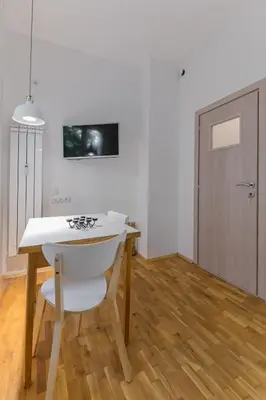 a kitchen with a table and a stove and a door at Bright Apartment in the Heart of the City by Flat Mаnager in Sofia