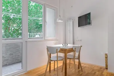 a dining room with a table and two chairs at Bright Apartment in the Heart of the City by Flat Mаnager in Sofia