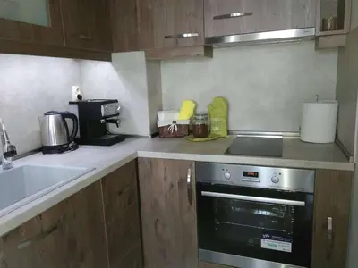 a kitchen with a sink and a stove top oven at Nev Apart New in Velingrad