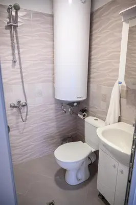 a bathroom with a toilet and a sink at Апартаменти ЗДРАВЕ in Sapareva Banya