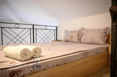 a bedroom with a bed with two towels on it at Апартаменти ЗДРАВЕ in Sapareva Banya