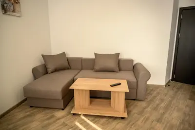 a living room with a couch and a coffee table at Апартаменти ЗДРАВЕ in Sapareva Banya