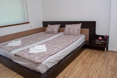 a bedroom with a bed with two towels on it at Central Apartment Mountain View in Karlovo